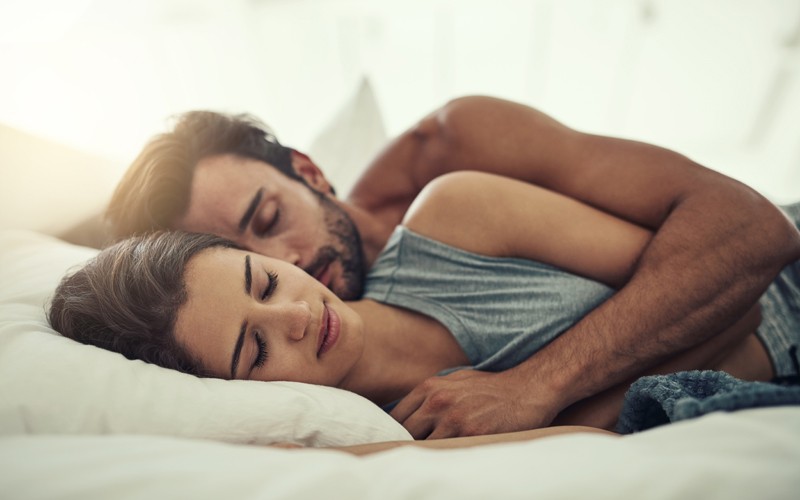 Cropped shot of an affectionate young couple sleeping in their bed